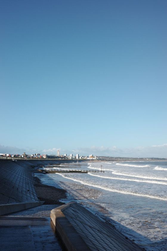 Beach: Curving shoreline from the grassy bank