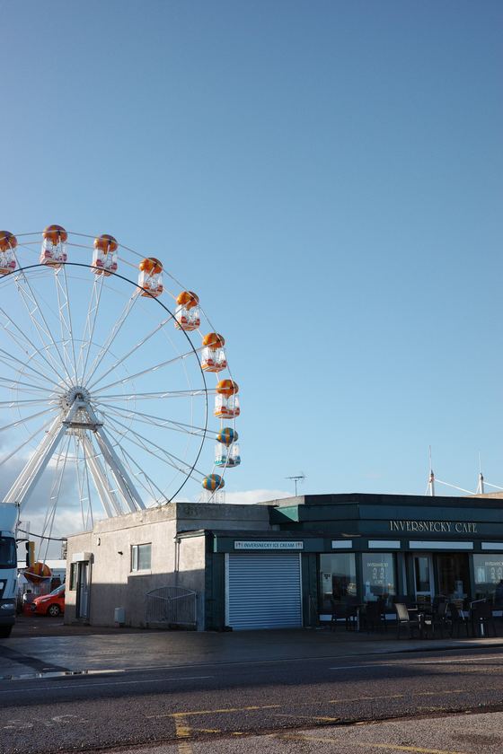 Beach: Seafront Ferris wheel under blue sky