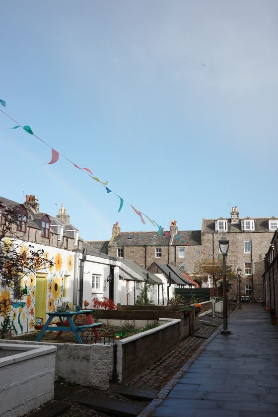 Footdee: Bunting above a cottage lane