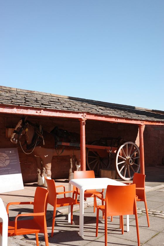 Docks: Orange café chairs beneath timber awning