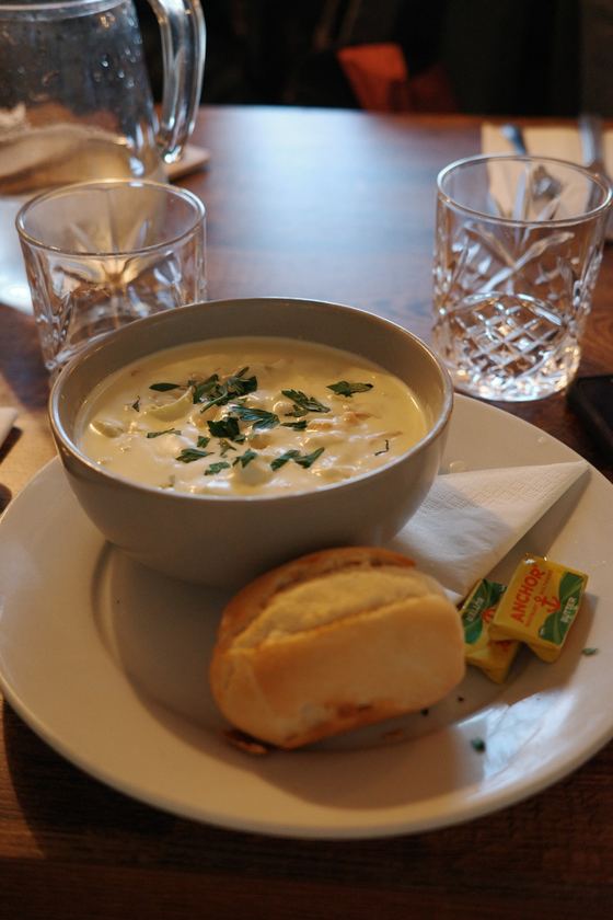 Docks: Seafood soup and bread at table