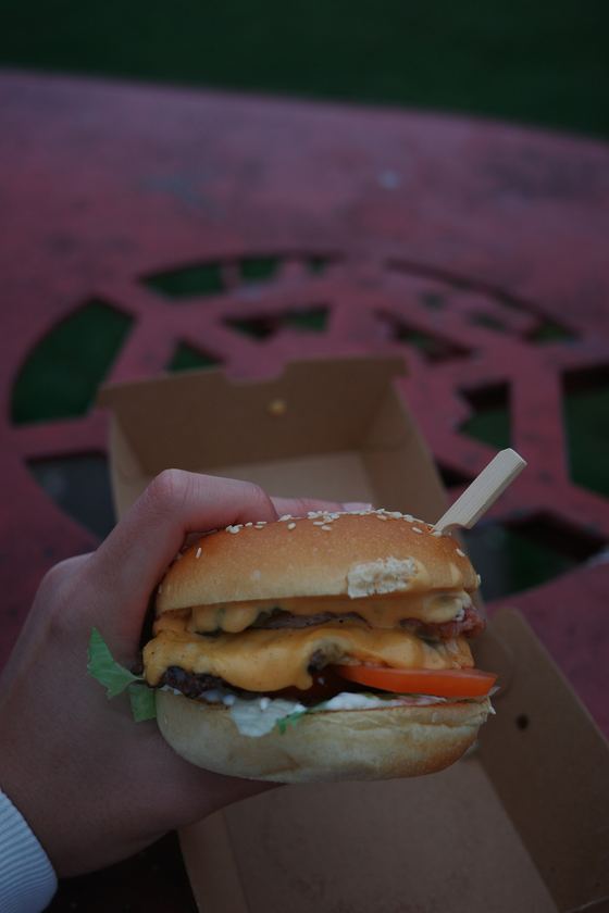 Arran: Burger held over outdoor table