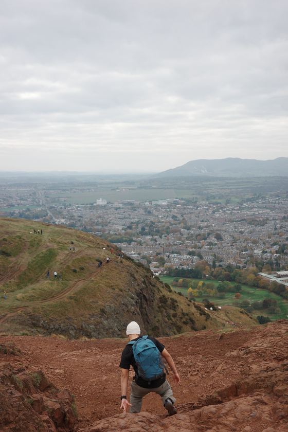 Arthur's Seat: Hiker overlooking Edinburgh from hillside