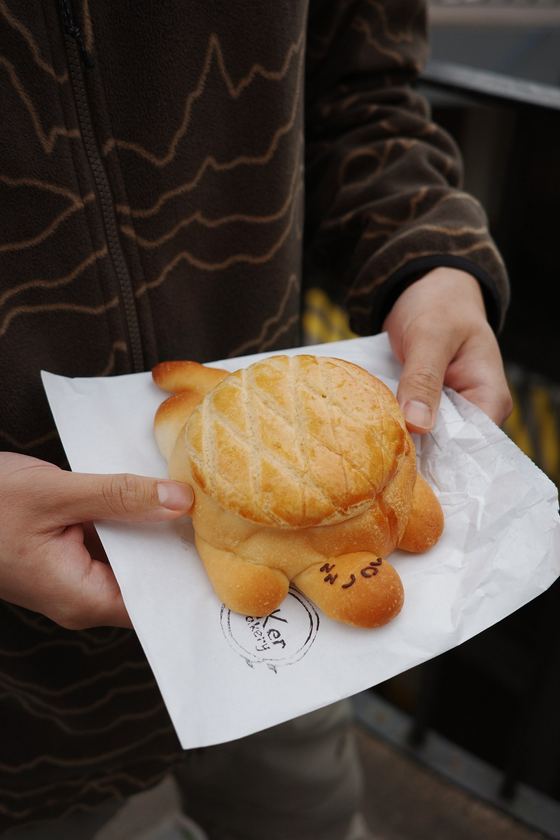 Market: Hand holding a golden pastry