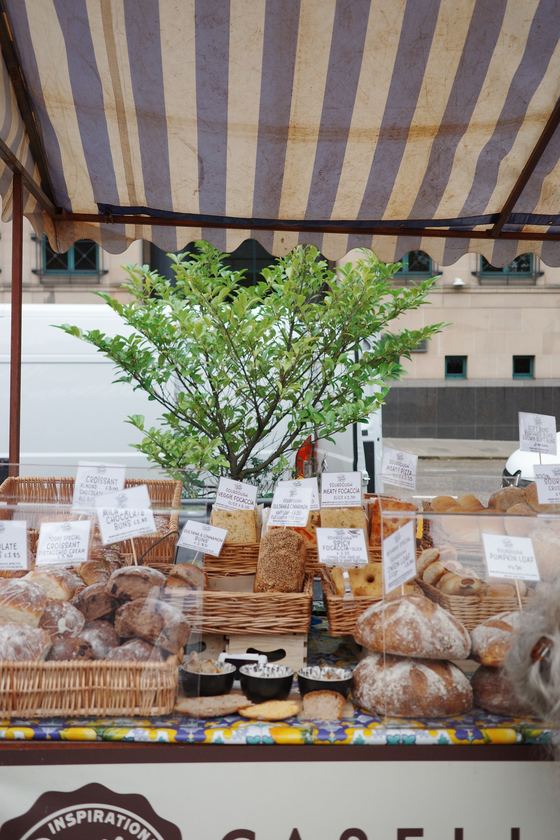 Market: Bread display beneath striped market canopy