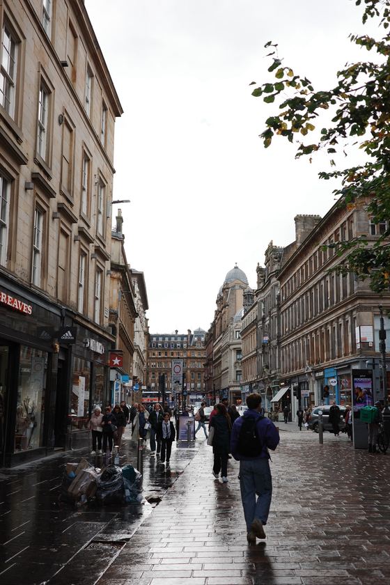 City centre: Pedestrians along a wet city street