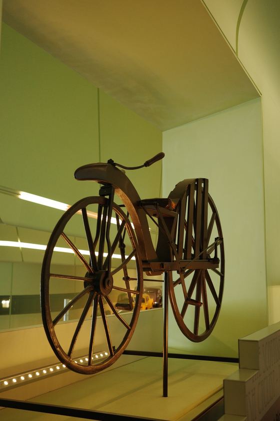Riverside Museum: Antique bicycle against pale wall