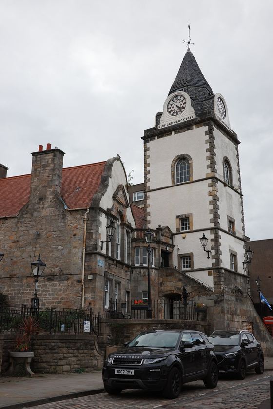 Queensferry: Stone clock tower above street