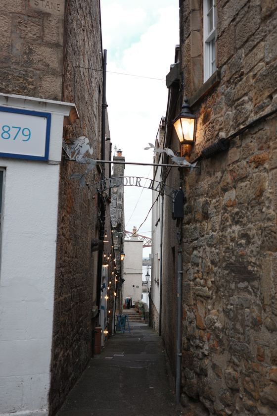 Queensferry: Narrow lane framing distant bridge