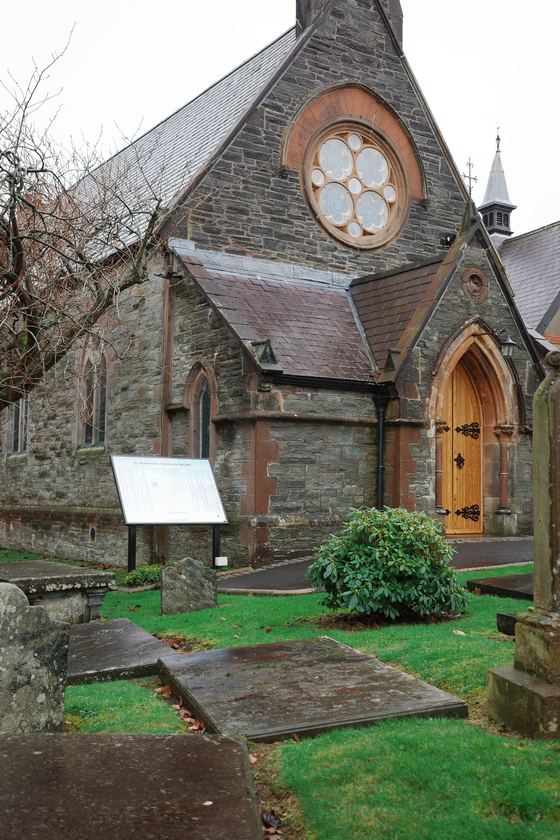 Derry: Stone church beside green lawn