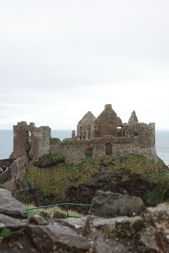 Giant's Causeway and the Dark Hedges: Castle ruins above rugged coast