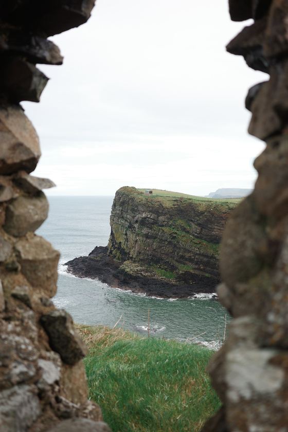 Giant's Causeway and the Dark Hedges: Coast framed by ruined stone