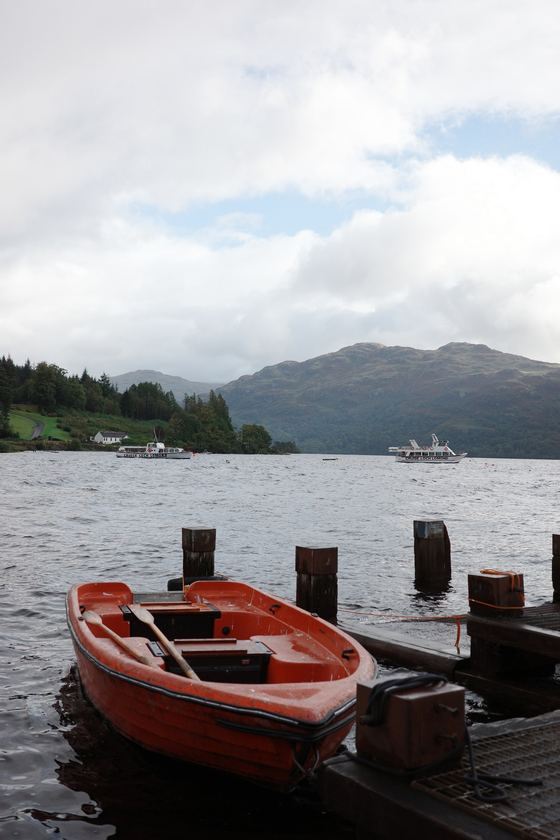 Rest and Be Thankful and Tarbet: Red boat beside mountain loch
