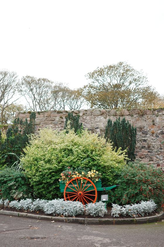 North Berwick: Flowering garden with red wagon wheel