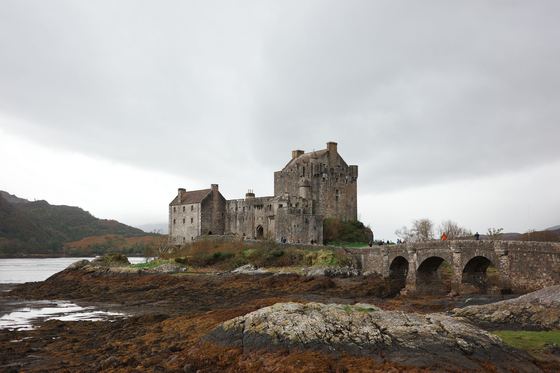 Eilean Donan: Castle above rocky shoreline