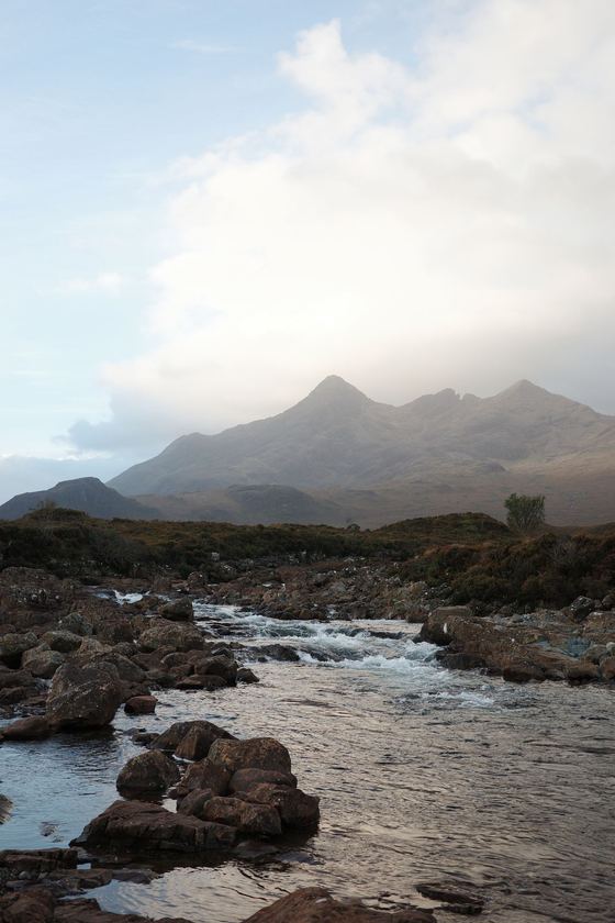 Sligachan: Rocky stream beneath mountain peaks