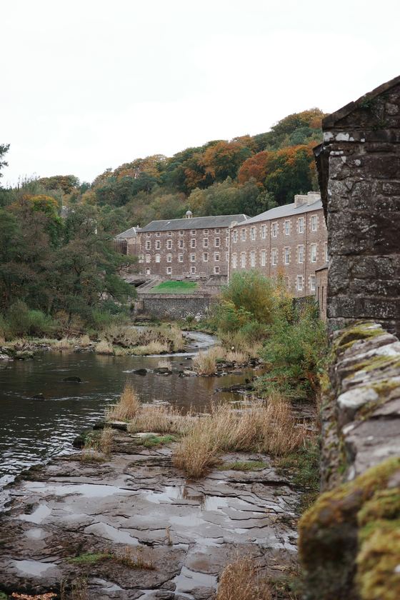 Lanark: Mill buildings beyond the rocky river
